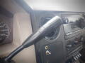 Close-up of the gear shift lever in a 2008 Ford F-550 with dashboard controls and gauges visible in the background