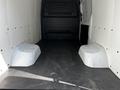 Interior view of a 2022 Mercedes-Benz Sprinter van with a spacious cargo area showing two wheel wells and a flat, dark floor