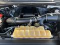 Engine compartment of a 2017 Ford F-150 featuring the engine block air intake and a yellow coolant reservoir