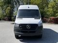 A 2022 Mercedes-Benz Sprinter van facing forward with a white exterior and a black grille featuring the Mercedes-Benz logo