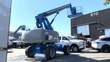 2008 Genie S-65 Boom Lift with a blue exterior and extendable arm positioned upright with a platform at the top