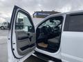 A 2017 Ford F-150 with an open driver's door revealing the interior and dashboard