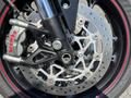 A close-up of the front wheel and brake system of a 2018 Triumph Street Triple RS showcasing the Brembo caliper and intricate rotor design