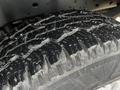 Close-up of a textured tire tread on a 2011 Ford F-250 SD showcasing deep grooves and uneven wear patterns