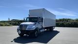 A white 2019 International 4300 box truck with an empty cargo area and a clear front view positioned on a pavement surface