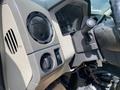 Interior view of a 2010 Ford F-550 showing the dashboard controls including air conditioning knob and vehicle controls