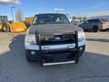 A 2013 Ford Expedition with a rugged appearance featuring a front grille guard and a partially covered hood