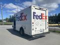 1999 Ford Econoline delivery truck painted in white with FedEx branding on the side including the FedEx Ground logo and website details