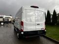 A white 2020 Ford Transit van viewed from the rear with a smooth body and large rear doors