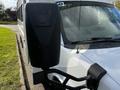 A 2015 Chevrolet Express van with a prominent side mirror and part of the front visible