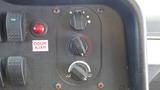 Control panel of a 2011 Ford Econoline featuring climate control knobs a fan switch and a door ajar indicator light