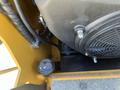 A close-up view of the engine compartment of a 2024 AGT KTT23 Mini Skid Steer showing a black cooling fan and various components including hoses and a cap