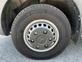 A close-up of a wheel from a 2022 Mercedes-Benz Sprinter featuring a metallic hubcap and a tire labeled LT 215/85 R16