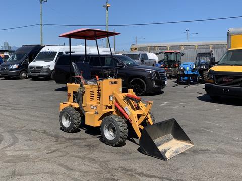 A 2024 Traner TR 45 compact loader with a front bucket and a protective canopy designed for construction and landscaping tasks