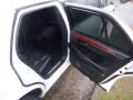 A 2008 Cadillac Limousine with an open door revealing a black leather interior and wood accents on the door panel