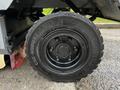 A close-up of the tire of a 2007 Tennant Sentinel with a black rim and tread pattern labeled CSE ROBUST SC 18 and CONTINENTAL 750-12 markings