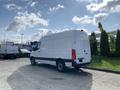 A white 2021 Mercedes-Benz Sprinter van with a high roof and cargo area, parked with its rear facing the viewer