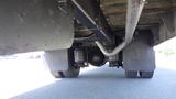 View of the underside of a 2014 International 3000 showcasing the rear axle suspension system and wheels