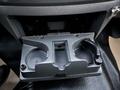 A gray plastic cup holder designed for a 2008 Dodge Ram 5500 with spaces for two cups and a compartment for small items