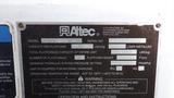 A metal identification plate displaying specifications for an Altec model AM556 with details on capacity platform and operating temperatures