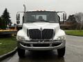 A 2011 International DuraStar 4300 front view showcasing its large chrome grille and distinctive hood design with prominent headlights and side mirrors