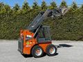 A 2017 Gehl R105 skid steer loader with an orange and gray body equipped with a bucket attachment and large wheels
