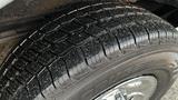 Close-up of a 2005 Chevrolet Express tire showcasing its tread pattern with visible water droplets on the surface