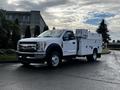 A 2017 Ford F-550 service truck with a white body and multiple compartments for tools and equipment