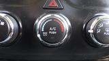 A dashboard control knob for the air conditioning system in a 2014 RAM 5500 with indicators for maximum air conditioning and push to activate