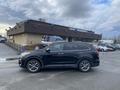 A black 2017 Hyundai Santa Fe parked in a lot with a sleek design and alloy wheels