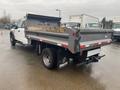 A 2021 Ford F-550 with a flatbed truck design featuring wooden planks secured in the truck bed and a robust rear configuration