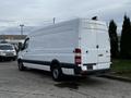 A white 2016 Mercedes-Benz Sprinter van is parked, showcasing its large cargo area and distinctive rear design with dual rear doors