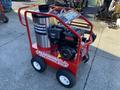 A red Magnum 4000 Hot Water Pressure Washer with a stainless steel tank and black engine mounted on a wheeled cart