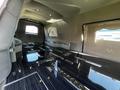Interior of a 2013 Lincoln MKT featuring a sleek black floor with metallic accents and seating along the sides