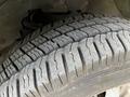 Close-up of a worn tire with visible tread patterns and grooves on a 2015 Chevrolet Express