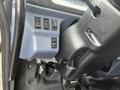 A close-up view of the dashboard controls in a 2008 Hino Conventional Cab showing buttons for various functions and a steering column
