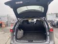 A 2021 Lexus NX 300 with its rear hatch open showcasing the spacious cargo area and folded rear seats