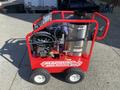 A red 2024 Magnum 4000 Hot Water Pressure Washer with a black handle and wheels featuring a large silver tank and various hoses and controls on a metal frame