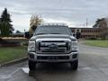 A 2013 Ford F-350 SD with a chrome front grille and amber roof lights positioned head-on showcasing its sturdy build and design