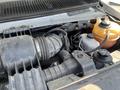 Close-up view of the engine compartment of a 2012 Ford Econoline showing various components including hoses and reservoirs