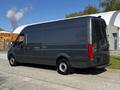 A 2021 Mercedes-Benz Sprinter van with a sleek grey exterior and a high roof design showcasing its spacious cargo area and large rear doors