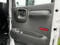 Interior door panel of a 2005 GMC C5 Duramax with a handle speaker grille and storage compartment