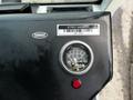 Close-up of the control panel of a 2007 Tennant Sentinel street sweeper featuring a gauge for air filter pressure and a red indicator light