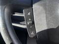 Steering wheel controls of a 2021 RAM Promaster including buttons for volume adjustment mute and voice command