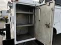 An open metal compartment with shelves inside a 2018 Ford F-550 truck