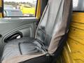 A black and grey seat inside the cab of a 2007 International 4300 truck