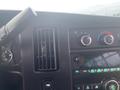 Dashboard and controls of a 2017 Chevrolet Express with air conditioning knobs and audio system display