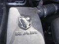 Close-up of the engine cover featuring the embossed RAM logo with a ram's head design on a dusty surface