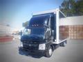 A 2013 Mitsubishi Fuso FE 160 truck with a black box cargo container and a cab with orange lights on top