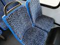 Two blue upholstered seats with a textured pattern inside a vehicle